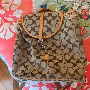 Brown small coach backpack with orange interior